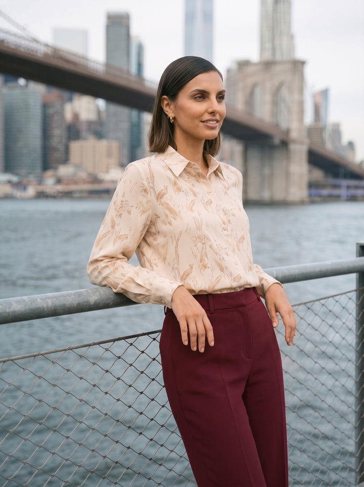 Model wearing the abstract print button-down shirt untucked with burgundy wide-leg trousers side 3
